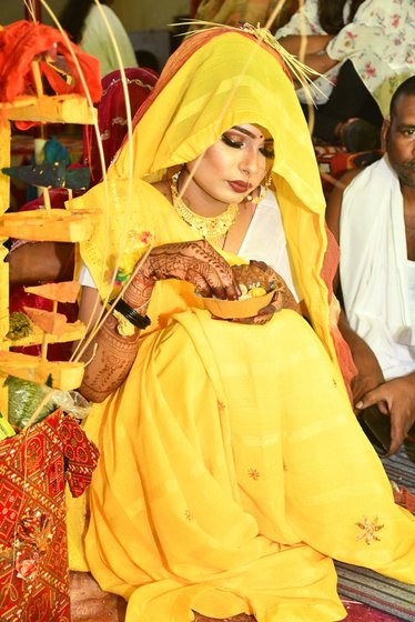 Bride seated during haldi rituals